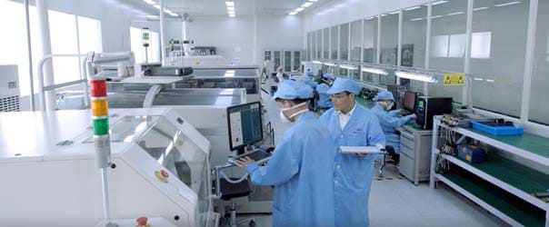 Factory workers assembling accelerometers, fiber optic gyroscopes, and MEMS IMUs.