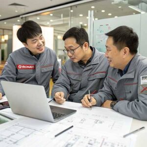 Three Chinese engineers discussing a product design in an office.